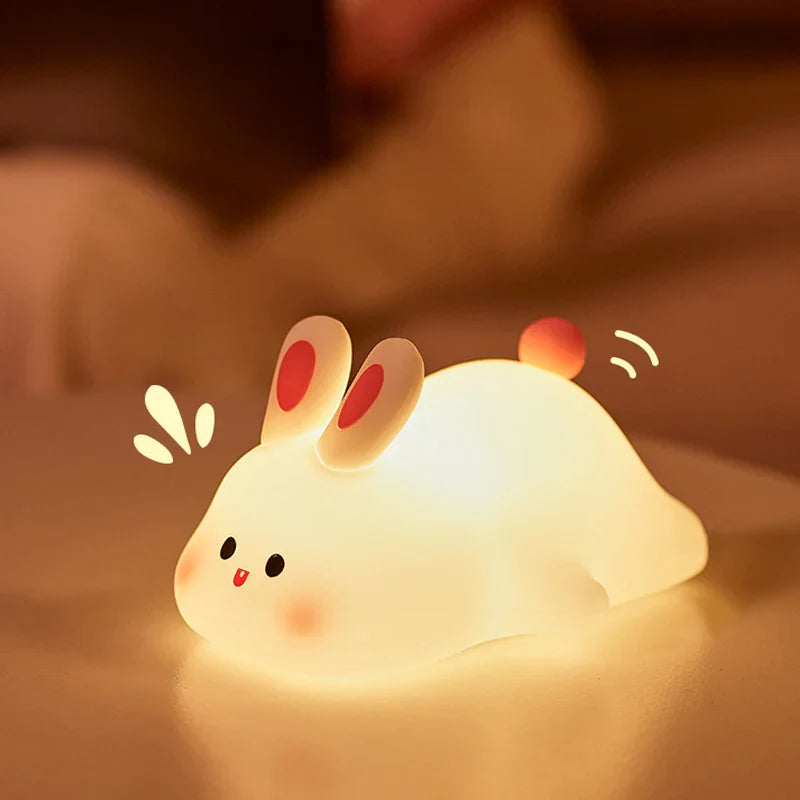 Cute rabbit-shaped night light on a soft surface